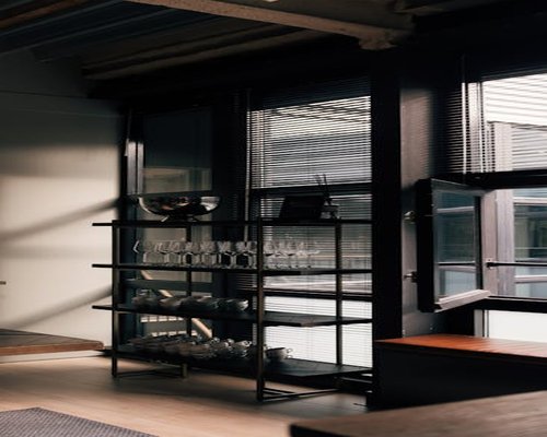 Sunlight streaming through half-open blinds into a living room